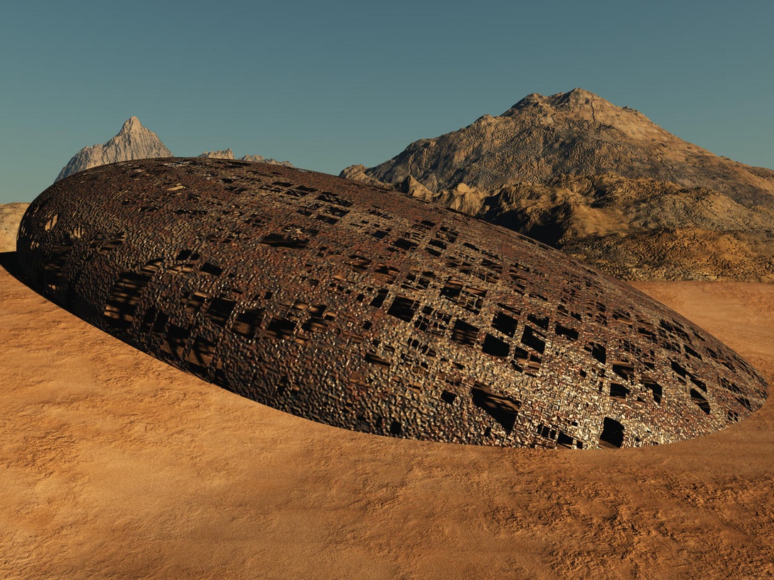 A digital rendering of a large, disc-shaped metallic object partially embedded in sandy desert terrain. The object has a weathered, textured surface with rectangular openings or panels. Mountains are visible in the background against a clear blue sky. This appears to be a science fiction representation of a UFO or alien craft on Earth.
